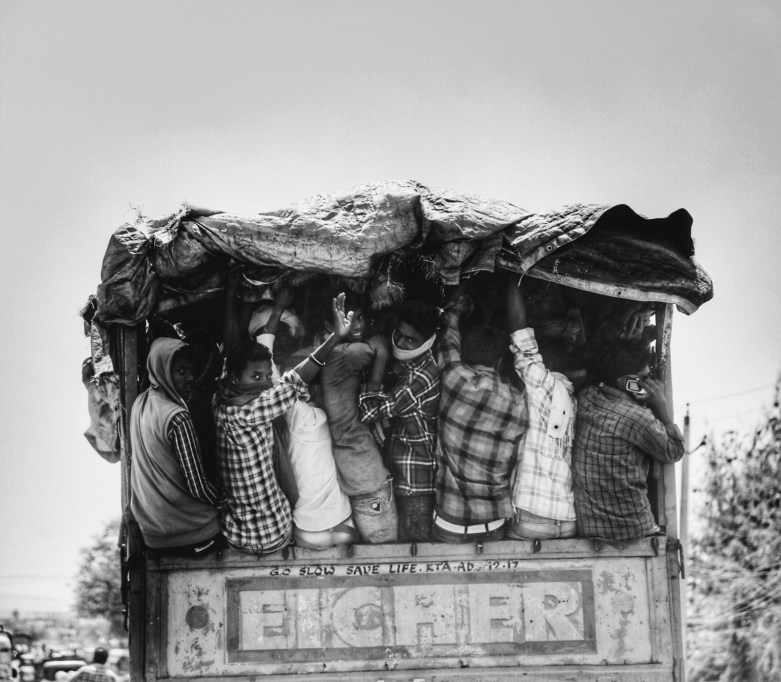 grayscale photo of man and woman standing on top of building