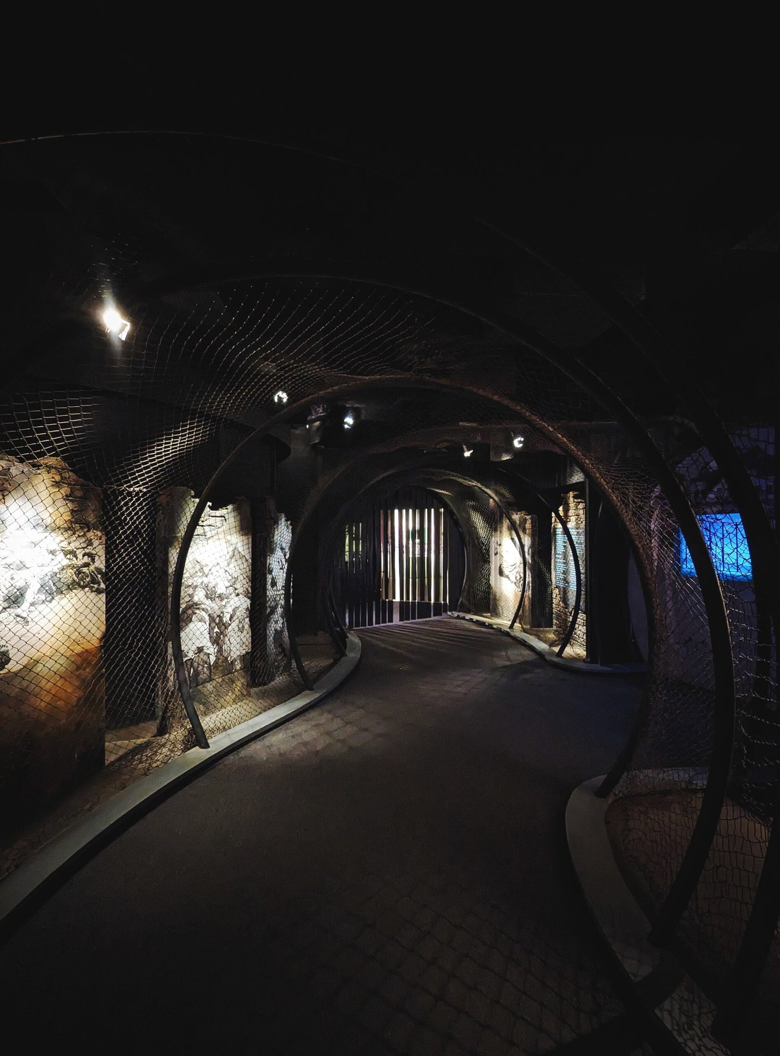 a dimly lit tunnel in the middle of a building