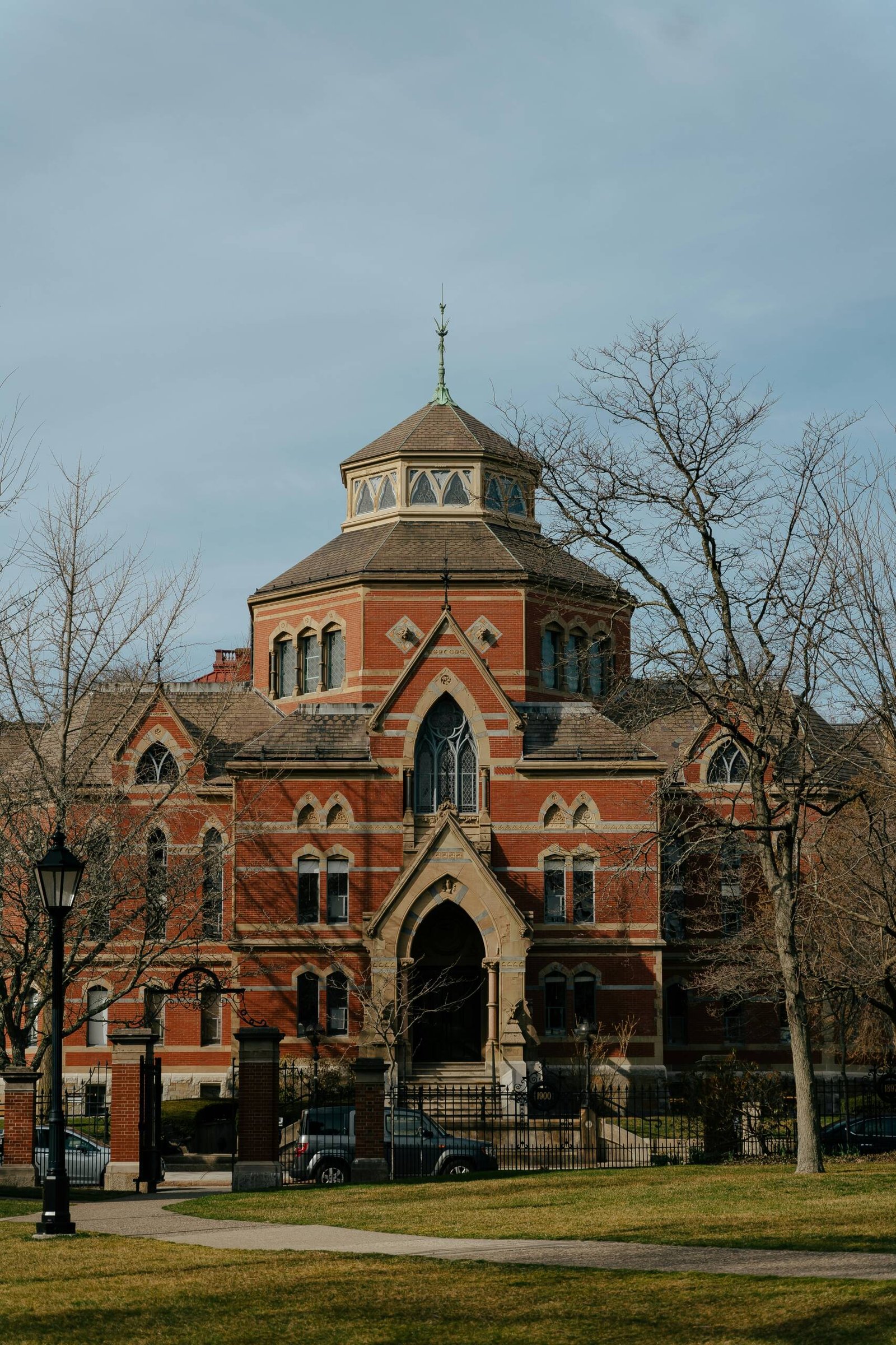 a large red brick building with a clock tower