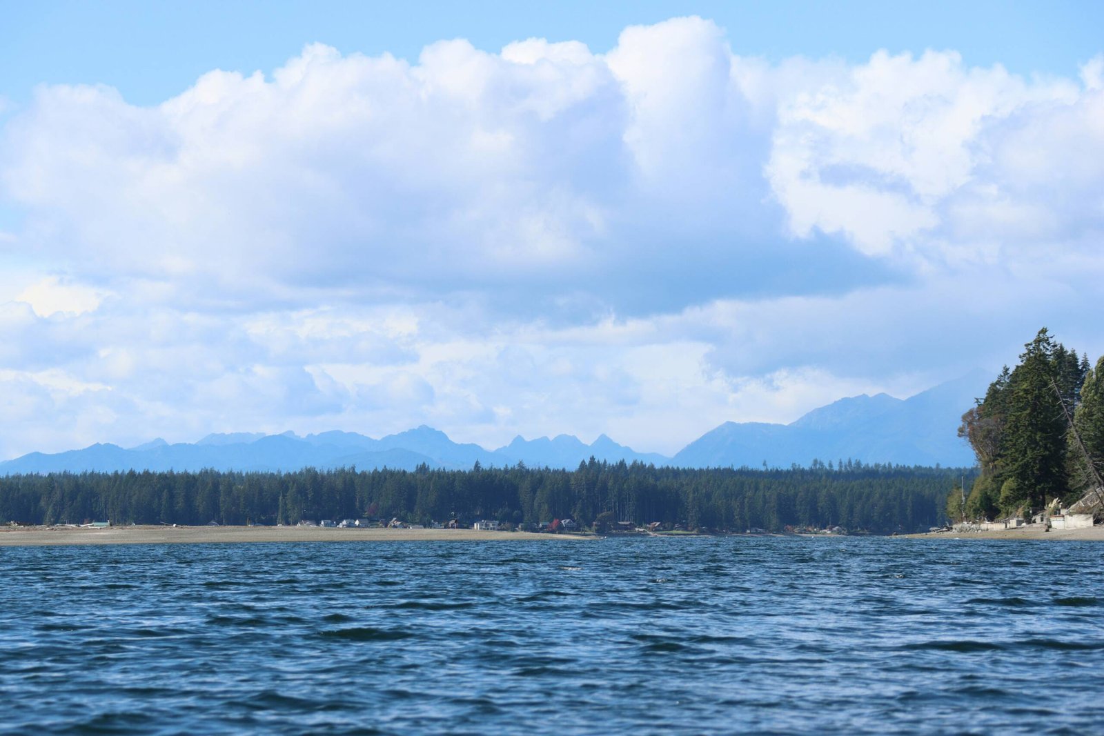 a large body of water with mountains in the background