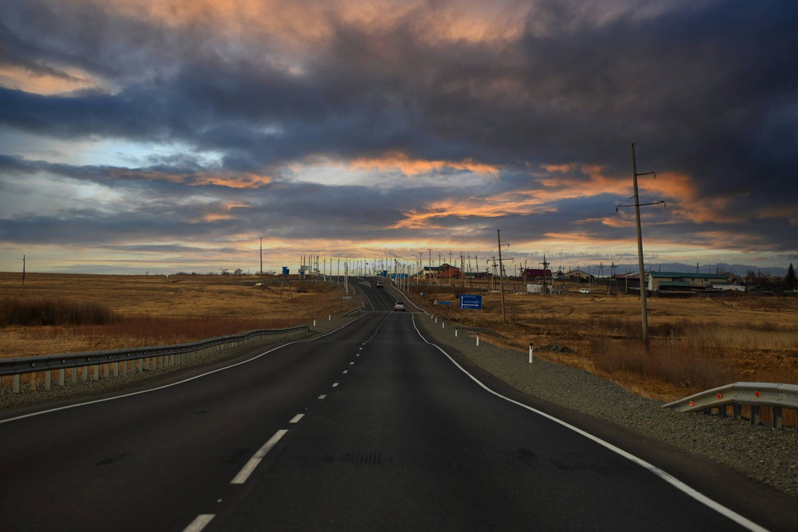 a road with a sunset in the background